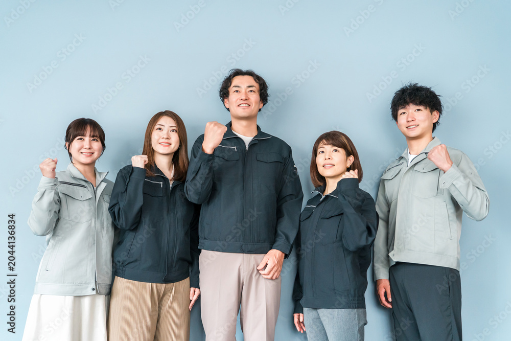 Fototapeta premium Employees and staff (businessmen and businesswomen) wearing work clothes at small and medium-sized enterprises such as factories and construction companies.