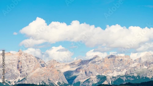 Timelapse Dolomites mountain range Italy jagged peaks moving clouds blue sky alpine landscape summer nature rocky limestone ridge scenic vista horizontal panorama outdoor environment banner background