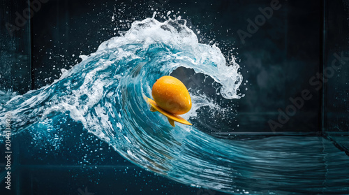 A vibrant mango on a surfboard dramatically rides a frozen blue wave in a studio.