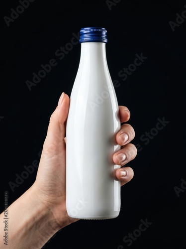 Hand Holding Blank White Milk Bottle Mockup on Black Background