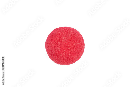 Red clown nose symbolizing joy, entertainment, and playfulness on a white background