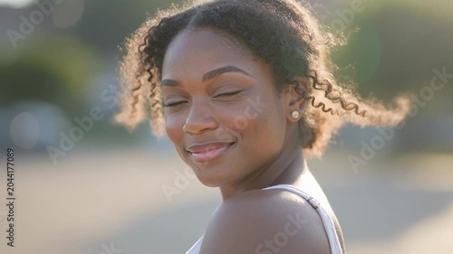 Solo Black woman portrait with soft smile in Juneteenth heritage celebration mood for cultural pride campaigns