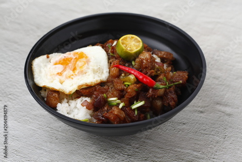 Filipino food called Sisig served as toppings on a rice bowl