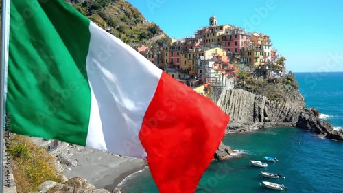 Italian Flag waving over Manarola Village in Cinque Terre Italy