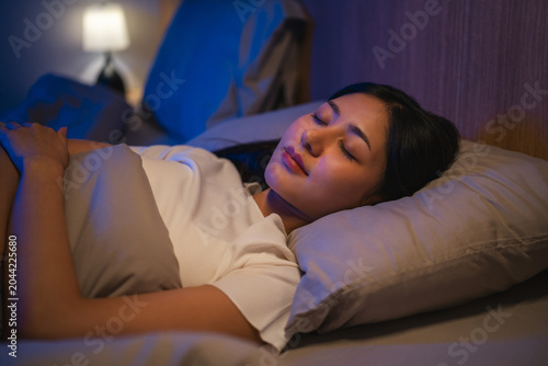 Obraz na płótnie Beautiful asian woman lying in the bed at night