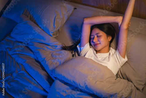 Canvas-taulu Beautiful asian woman lying in the bed at night
