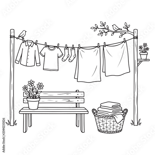 Clothes drying on a line with a bench and laundry basket