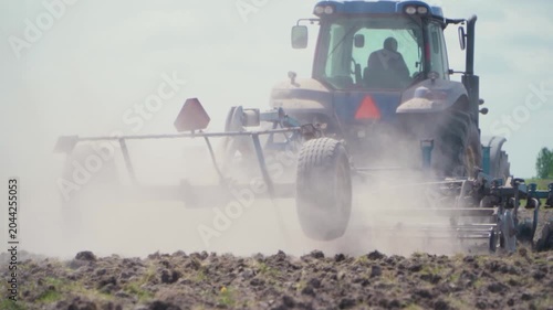 Agricultural Disc Harrow Cultivating Soil on Farm Field