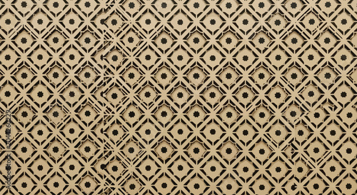 Foto Traditional islamic tile pattern in dark brown and beige featuring intricate floral stars and geometric lattice motifs for cultural architectural textures