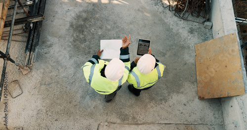 Картината върху платно People, architect and team with tablet or blueprint on construction site for building design
