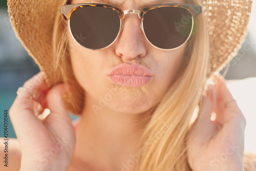 Fotografie Kiss, sunglasses and travel with woman outdoor for getaway, holiday or vacation in summer