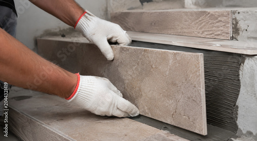 man laying tiles on stairs close-up, empty space for text, template, photo background, layout, banner