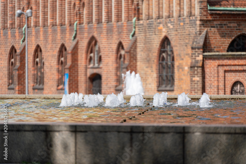 Bilde på lerret A low row of fountain jets sparkles in front of Berlin's Rotes Rathaus