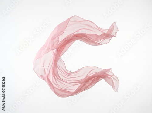 Elegant pink silk fabric swirling in soft light minimalist abstract composition