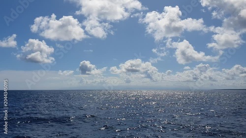 various shapes of clouds in the sky above the choppy sea