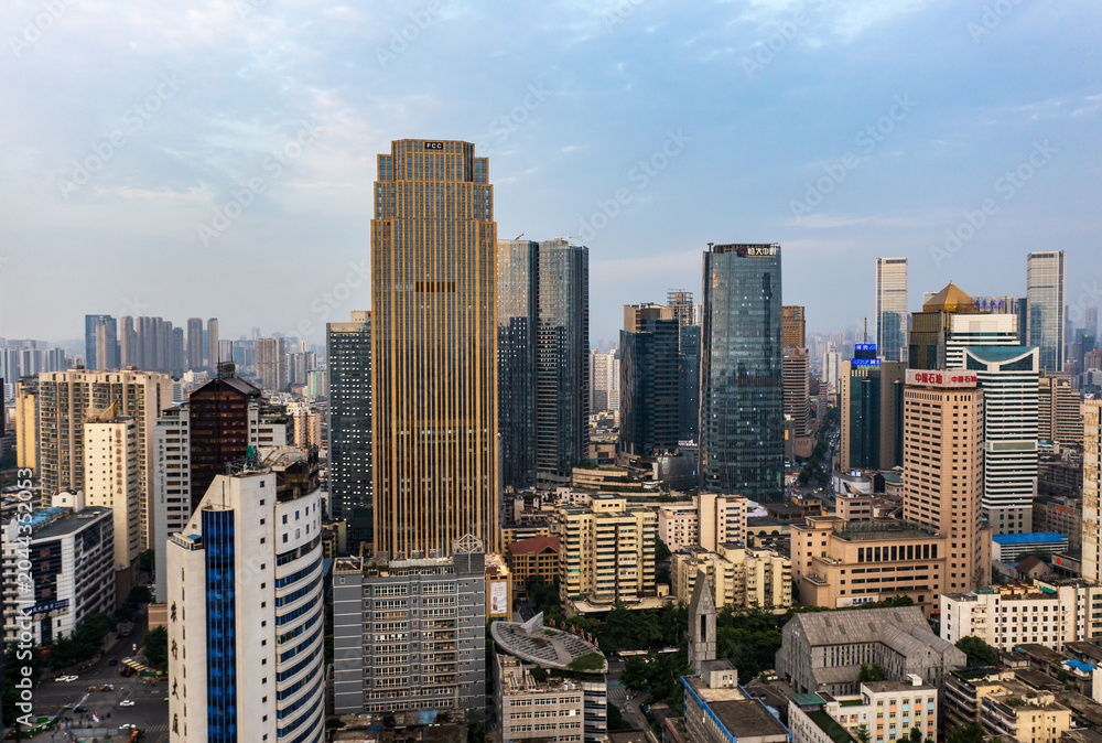Obraz premium Aerial sunset city skyline of downtown Chengdu, dense modern high-rise office buildings and urban business district scenery at dusk, Sichuan China