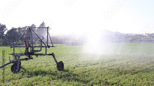 Mobile Sprinkler System Watering Green Field