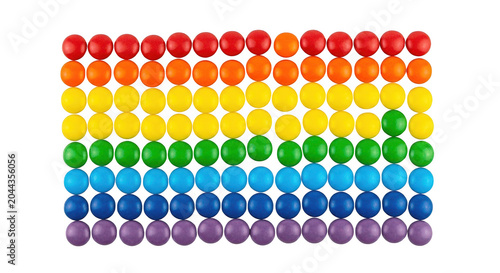 Colorful candy coated chocolate buttons arranged in a rainbow pattern isolated on transparent background