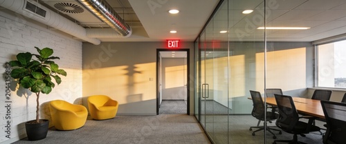 Modern Office Interior with Glass Conference Room and Yellow Chairs during Golden Hour