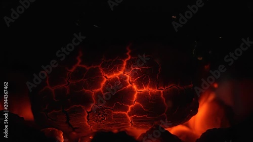 Glowing red lava with a cracked surface in a dark environment