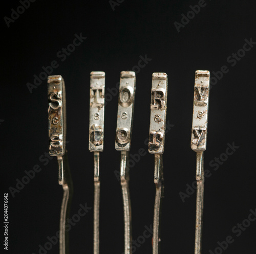 The word story with vintage typewriter hammers isolated on black 