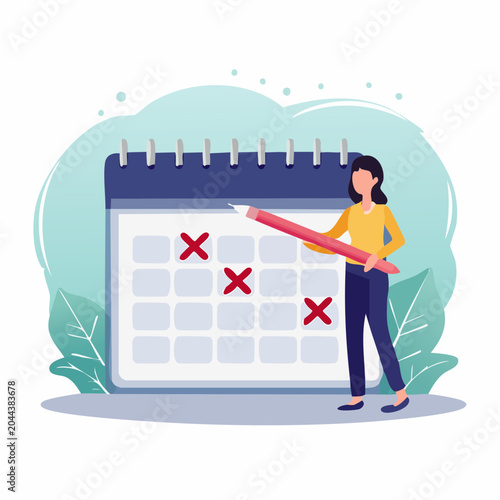 Woman marking dates on a calendar with a pencil