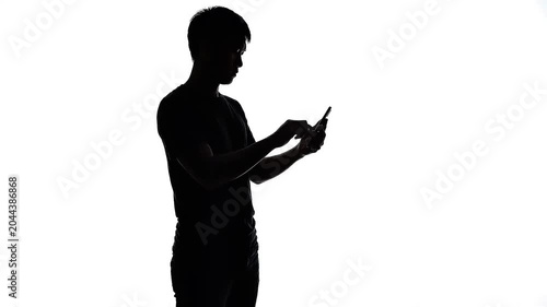 Silhouette of a man using smartphone on white background