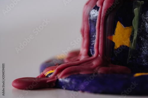 Closeup of melted red wax texture on handmade candle holder