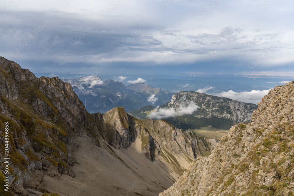 Fototapeta premium Scenic alpine mountains near the Col de la Colombière in the Bornes-Aravis massif with green meadows and rugged peaks, Haute-Savoie, French Alps