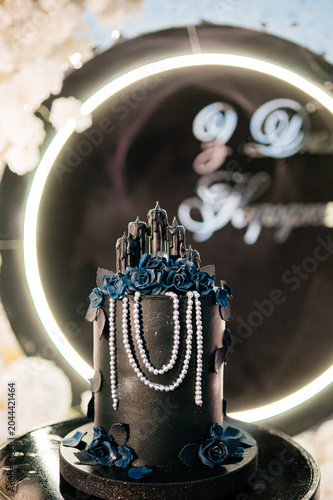 Gothic black birthday cake with dark roses and pearl strings