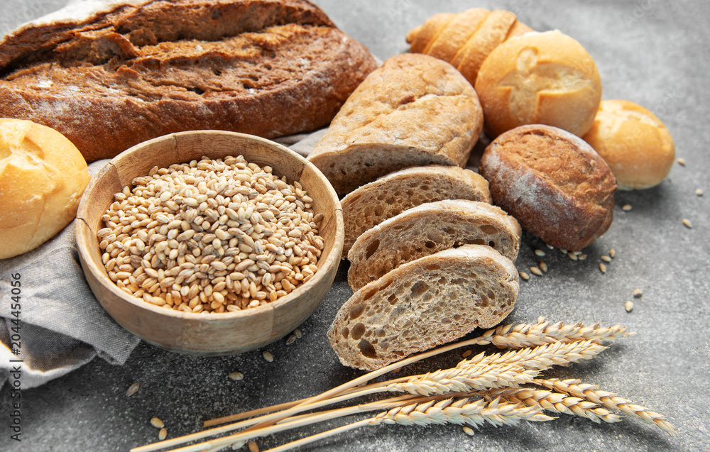 Naklejka premium Assorted fresh oven baked bread products with wheat