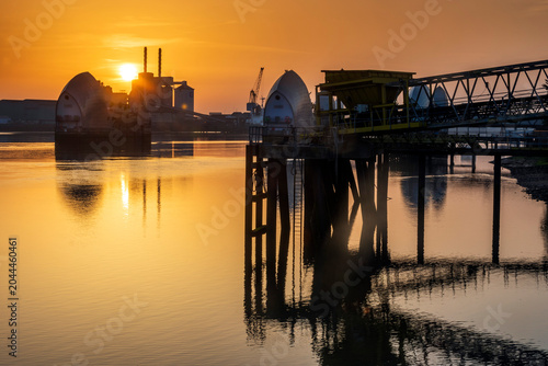 Bild auf Leinwand Sunrise view along the River Thames to the Thames Flood Barrier and industry, Lo