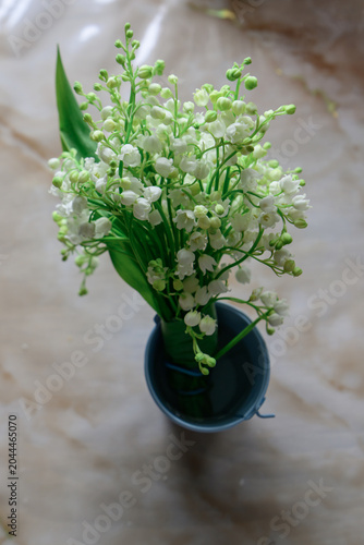 lily of the valley in a vase on a light background