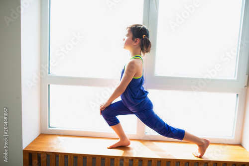 Photos Little girl forward lunge workout at home