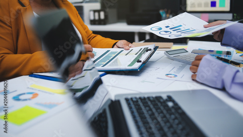 Obraz na plátně Auditor and accountant team working in office, analyze financial data and accounting record with calculator