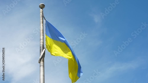 National flag of Ukraine waves tranquilly beside local administrative