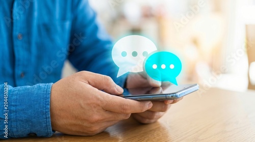Person holding smartphone with hovering social media message bubbles and chat icons smartphone messaging communication technology internet connection interaction