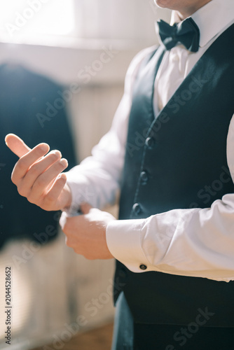 Slika na platnu Refined man fixing stylish cufflinks
