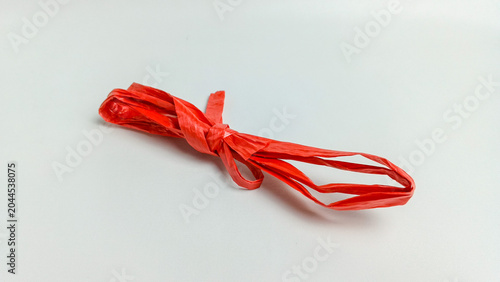Foto Red raffia rope over white background