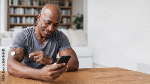 Man Monitoring Glucose Levels Using Mobile Health App