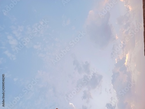 Peaceful Atmosphere Concept with Golden Light Illuminating White Clouds