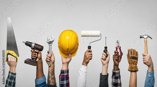 Diverse Workers Holding Essential Tools for Building & DIY