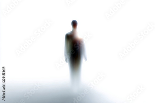 Ethereal ascending spirit silhouette in a soft beam of light minimal background for wallpaper and meditative design