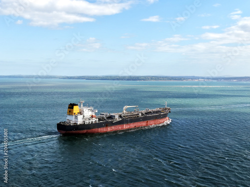 Aerial high angle view of an industrial oil tanker ship sailing in the open sea