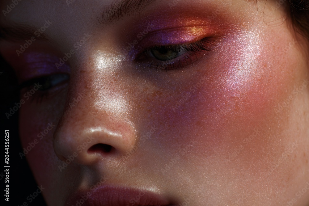 Naklejka premium Close-up metallic pink and orange editorial makeup on model face for beauty background and cosmetic banner design