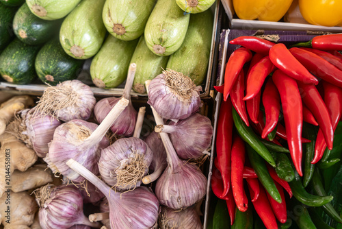 Fresh organic rustic vegetables with garlic zucchini and red chili peppers in boxes perfect for supermarket grocery retail business and food delivery advertising at local market