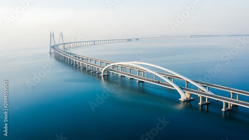 A professional product photography shot of a large bridge over calm water