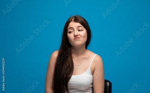 Bilde på lerret Young woman doubting, expressing skepticism and disbelief, looking away with a q