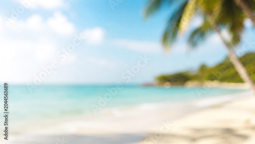 tropical beach landscape with blurred palm tree and turquoise ocean. Sunny summer scenery for vacation and travel inspiration. Relaxing coastal view for holiday background design