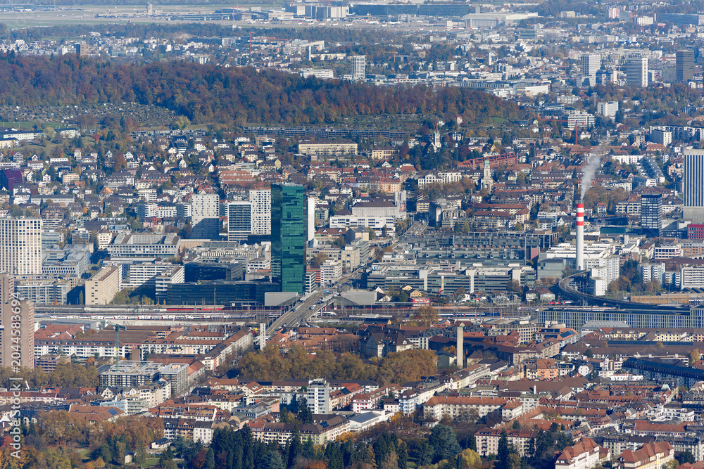 Fototapeta premium Aerial view of cityscape with Hardbrücke bridge and Prime Tower skyscraper at industrial district of Swiss city of Zürich on a sunny autumn day. Photo taken October 29th, 2025, Zurich, Switzerland.